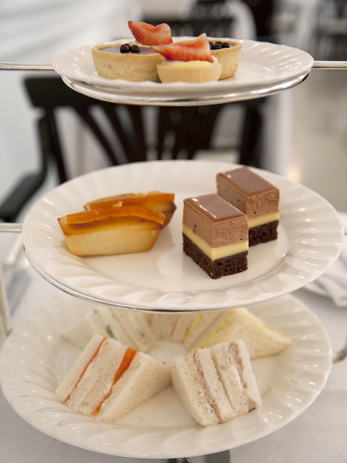 Raffles High Tea Platter with three tiers of food, white china.