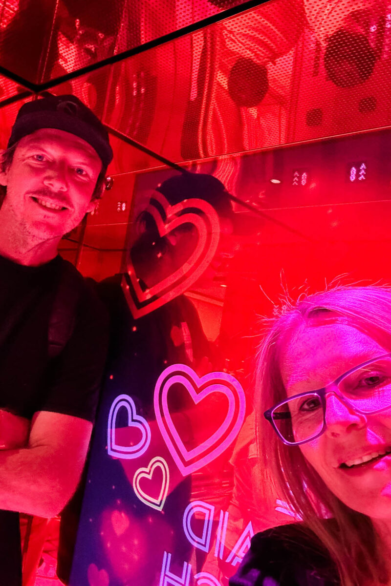 Bright picture showing the lights in the lift for Valentines Day on the Virgin Voyages Ship